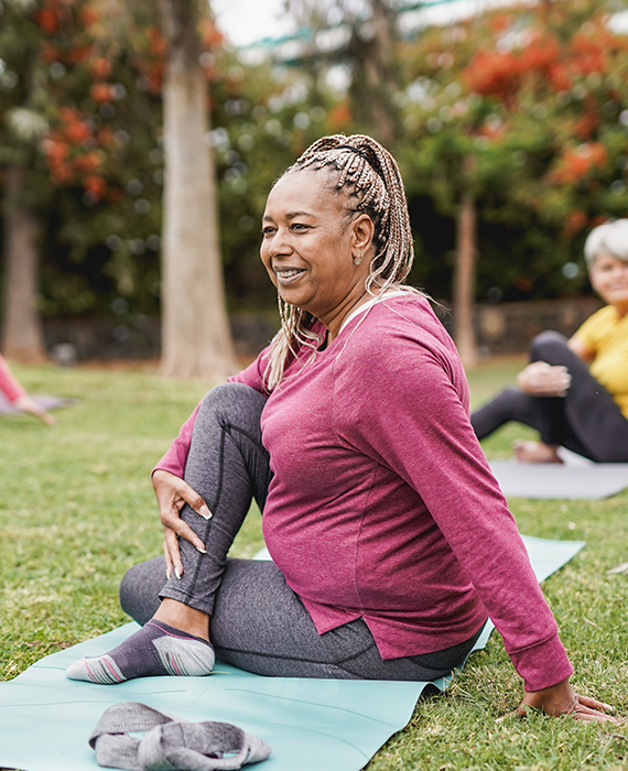 Photo of a woman attending an outdoor yoga class