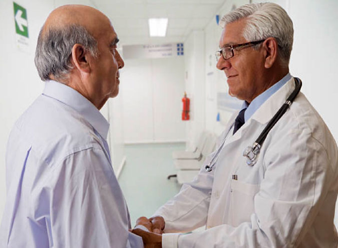 Image of a doctor shaking hands with a patient