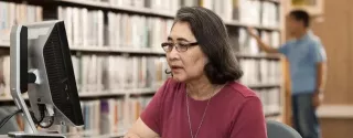 Person looking at computer in a library