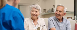 Nurse talking with patient at home