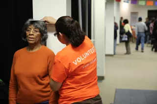 Photo of a woman being measured for height
