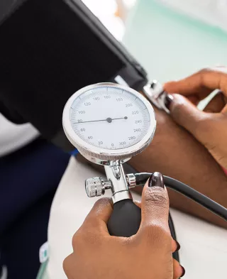 Close up on a blood pressure cuff on a woman's arm